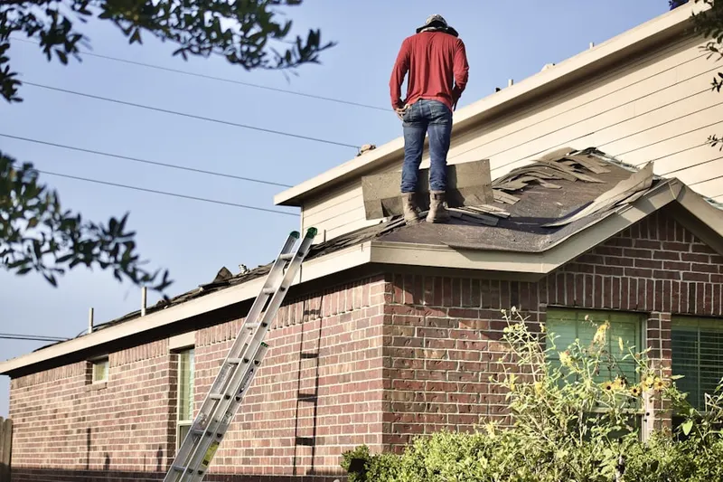 Professional roofer working on a residential roof in Cutchogue